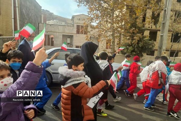 غبارروبی مزار شهدا توسط دانش‌آموزان رودهن در هفته بسیج