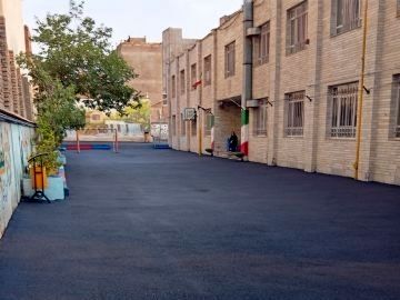 هنرستانی که به همت مدیر و مشارکت شهرداری، آسفالت‌ریزی شد